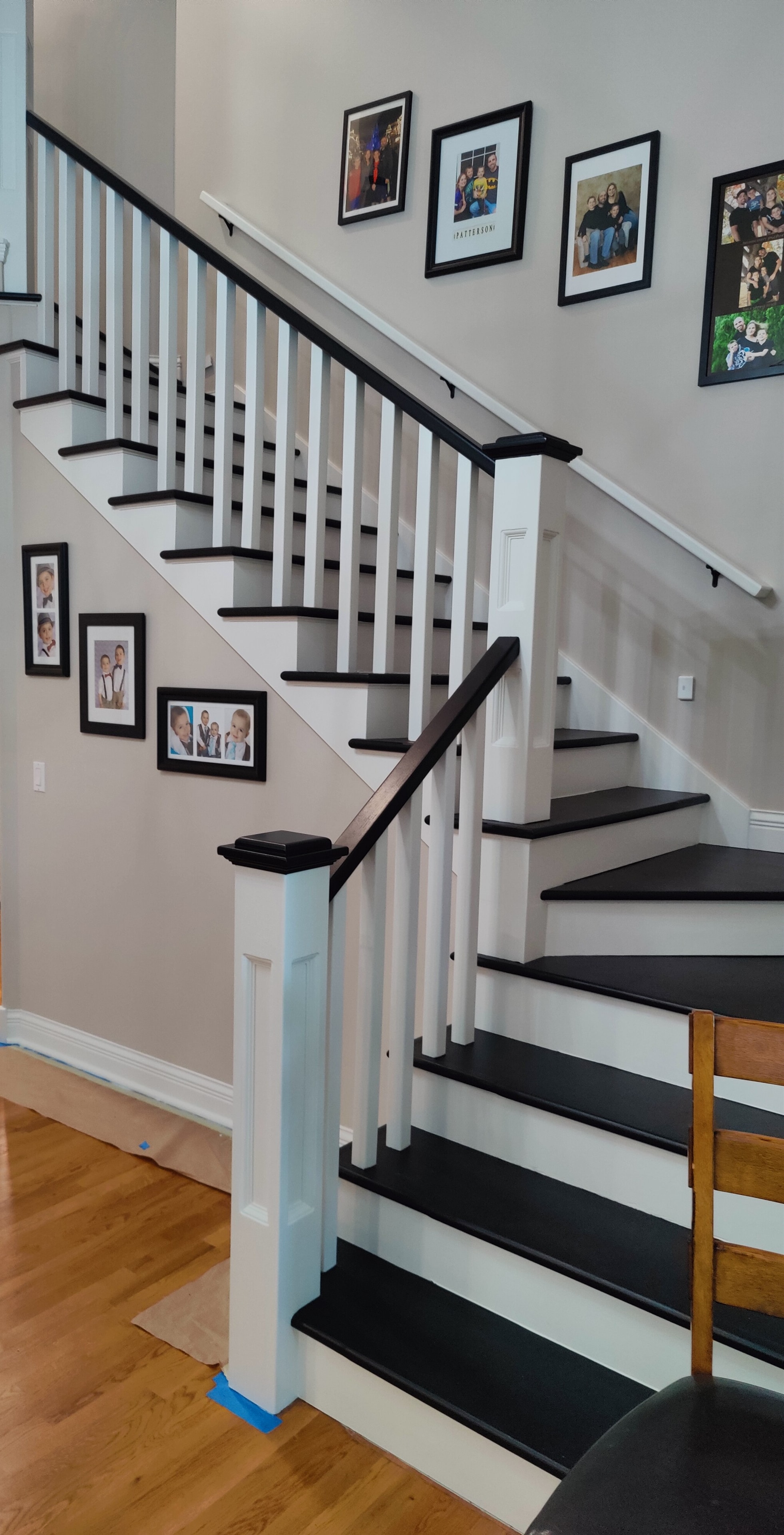 Staircase with painted black treads, white risers, and white railings — Caledonia, MI